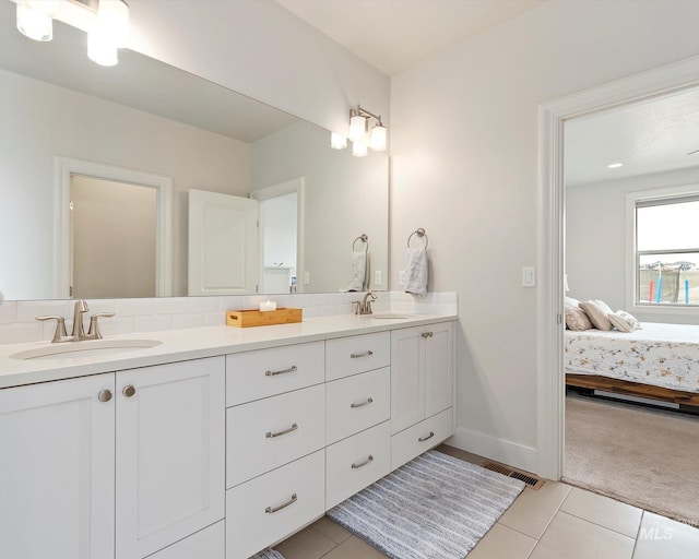 full bath with a sink, visible vents, ensuite bathroom, and double vanity