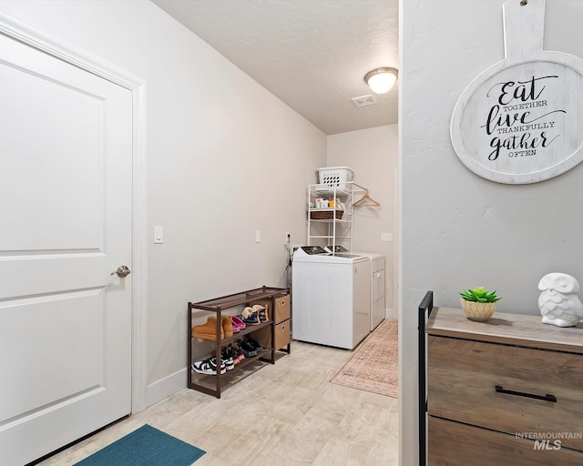 laundry room with laundry area, visible vents, and washing machine and clothes dryer