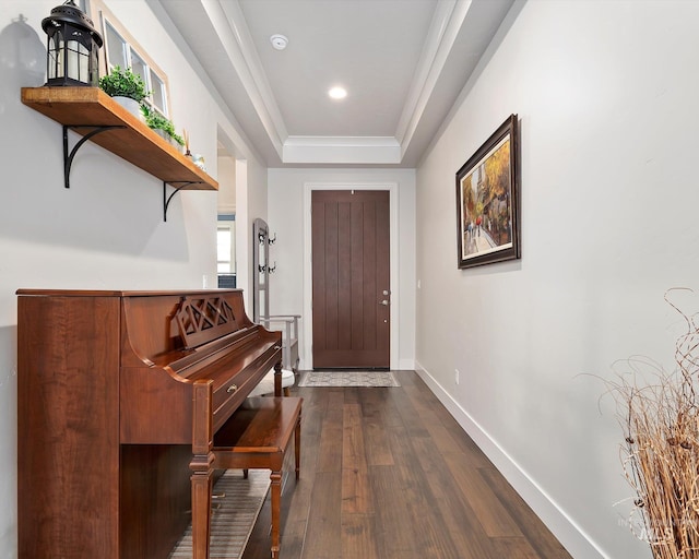 entryway featuring dark wood-style floors, recessed lighting, a raised ceiling, and baseboards