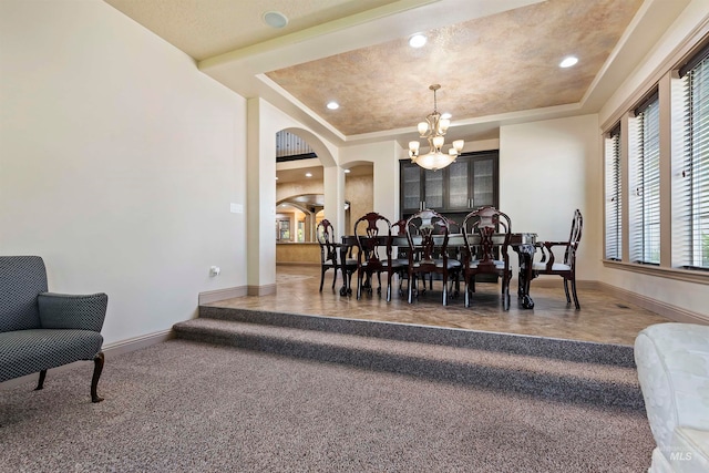 4315 N Nuova Ave, Meridian, ID 83646 - carpeted dining room with arched walkways, a notable chandelier, recessed lighting, a raised ceiling, and baseboards