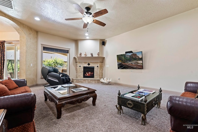 4315 N Nuova Ave, Meridian, ID 83646 - carpeted living room with arched walkways, a textured ceiling, visible vents, and baseboards