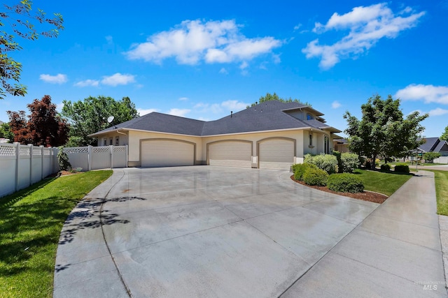 4315 N Nuova Ave, Meridian, ID 83646 - view of front facade featuring a garage, fence, a front lawn, and stucco siding