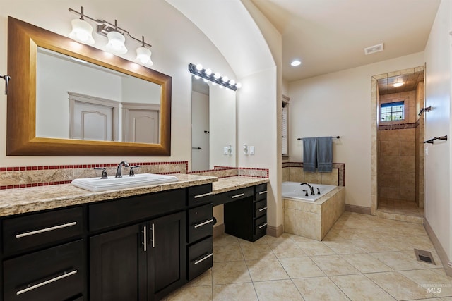 4315 N Nuova Ave, Meridian, ID 83646 - full bath featuring a walk in shower, a garden tub, visible vents, and tile patterned floors