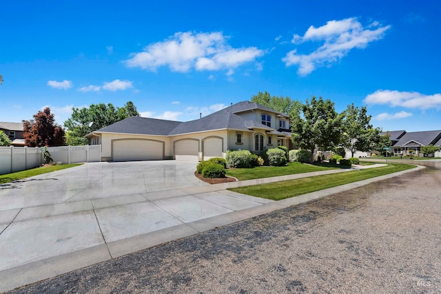 4315 N Nuova Ave, Meridian, ID 83646 - view of front of property with an attached garage, fence, driveway, stucco siding, and a front yard
