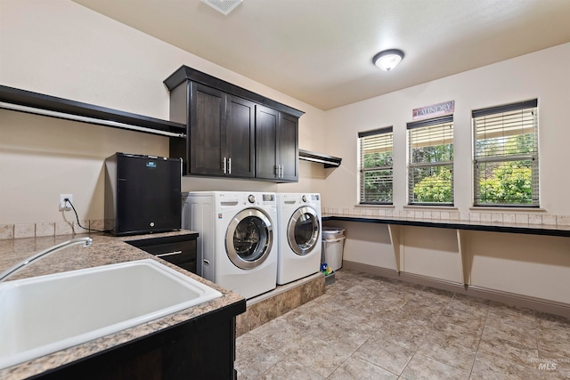 4315 N Nuova Ave, Meridian, ID 83646 - laundry area with cabinet space, visible vents, washing machine and dryer, a sink, and baseboards