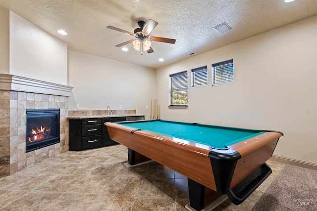 4315 N Nuova Ave, Meridian, ID 83646 - recreation room with recessed lighting, visible vents, a tiled fireplace, a ceiling fan, and a textured ceiling