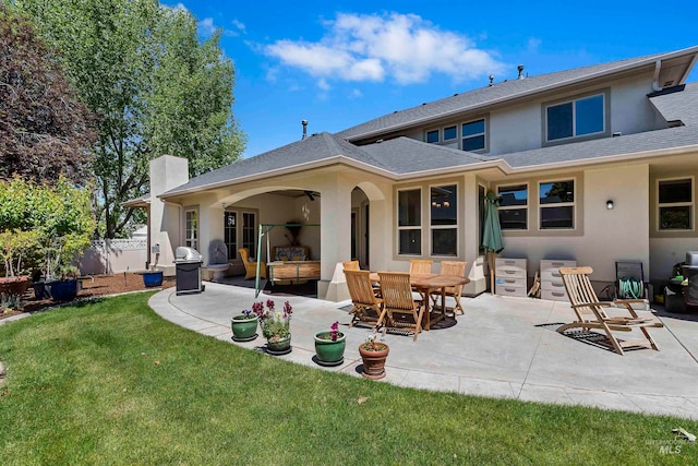 4315 N Nuova Ave, Meridian, ID 83646 - back of house featuring a patio area, roof with shingles, a yard, and stucco siding