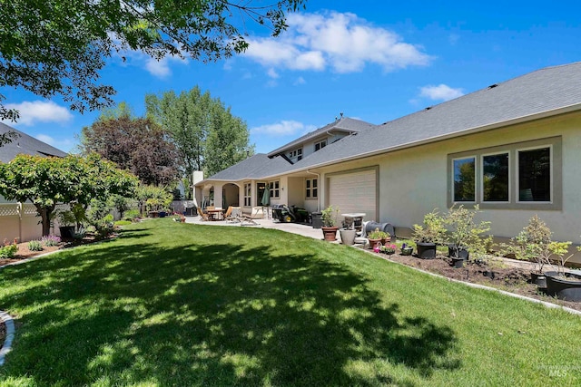 4315 N Nuova Ave, Meridian, ID 83646 - rear view of property featuring a garage, fence, a yard, a patio area, and stucco siding