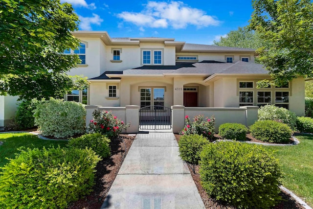 4315 N Nuova Ave, Meridian, ID 83646 - prairie-style home with a fenced front yard, a gate, and stucco siding
