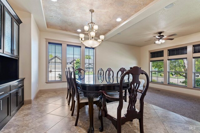 4315 N Nuova Ave, Meridian, ID 83646 - dining room featuring a tray ceiling, light tile patterned floors, light carpet, a textured ceiling, and baseboards