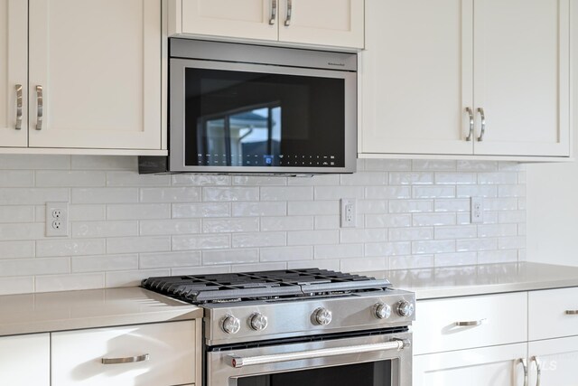 kitchen featuring white cabinets, light countertops, and stainless steel appliances