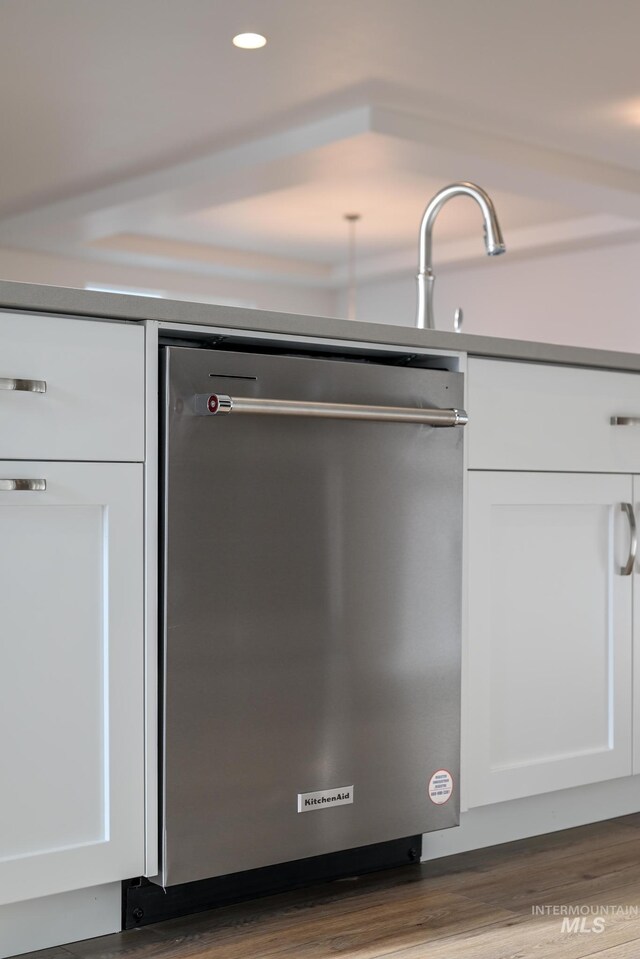 interior details featuring white cabinetry, wood finished floors, recessed lighting, and dishwasher