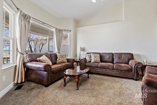 living area with carpet floors, baseboards, and visible vents