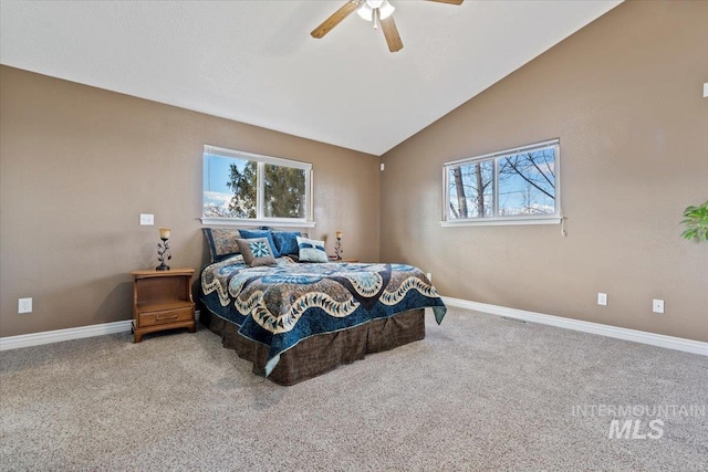 carpeted bedroom with multiple windows, vaulted ceiling, baseboards, and ceiling fan