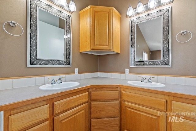 bathroom with a sink and double vanity