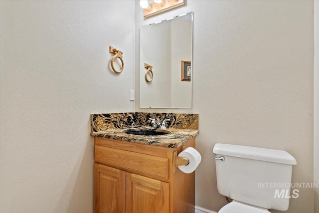 bathroom featuring toilet and vanity