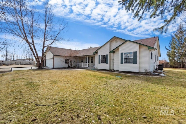 single story home featuring central air condition unit, covered porch, an attached garage, and a front yard