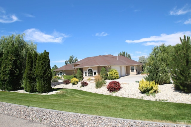 single story home with a front yard and a garage