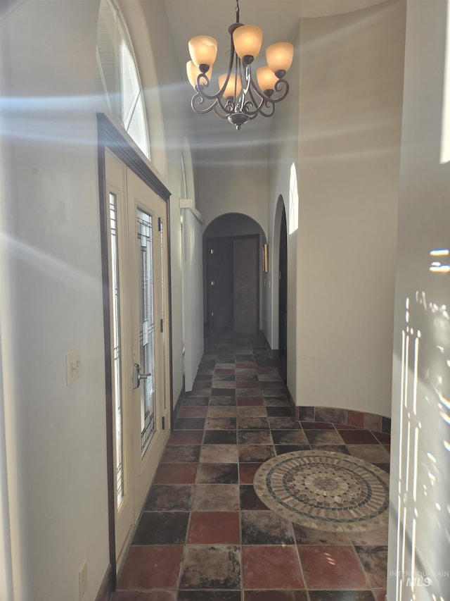 corridor with an inviting chandelier