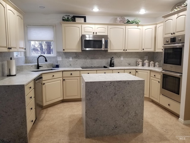 kitchen featuring sink, backsplash, stainless steel appliances, and a kitchen island