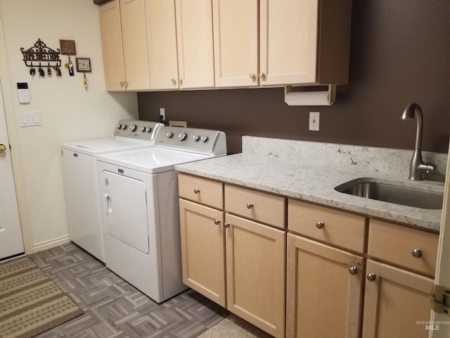 laundry area featuring sink, cabinets, and independent washer and dryer