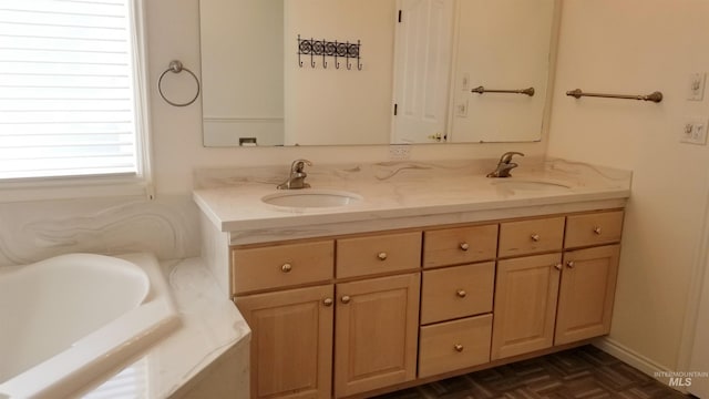 bathroom with parquet floors, vanity, and a bath