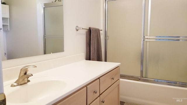 bathroom with enclosed tub / shower combo and vanity