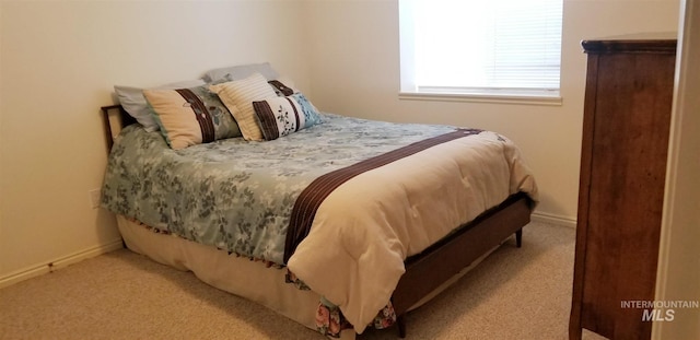 bedroom featuring light carpet