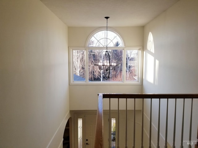 stairs featuring an inviting chandelier