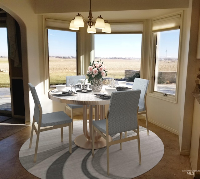 dining room featuring a rural view and an inviting chandelier