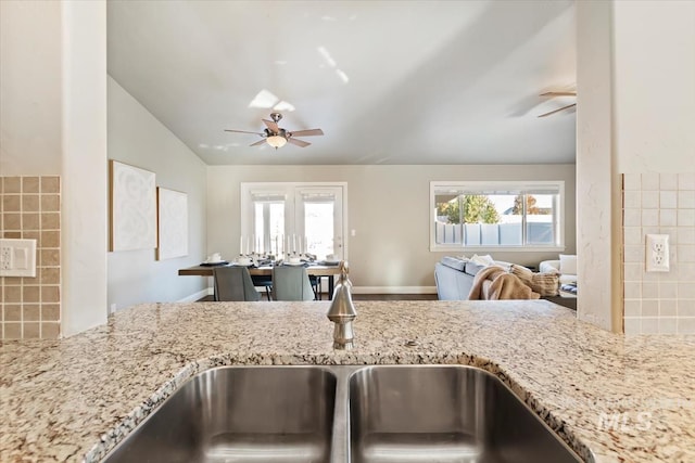 kitchen featuring decorative backsplash, sink, ceiling fan, and plenty of natural light