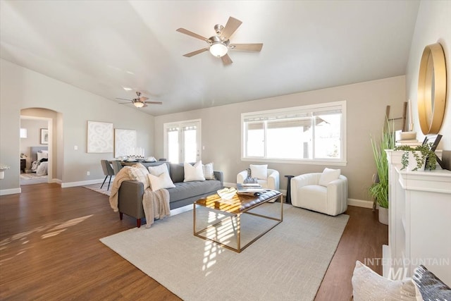 living room with lofted ceiling, ceiling fan, and dark hardwood / wood-style flooring