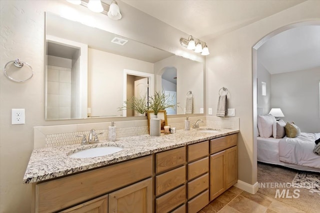 bathroom with tile patterned flooring and vanity