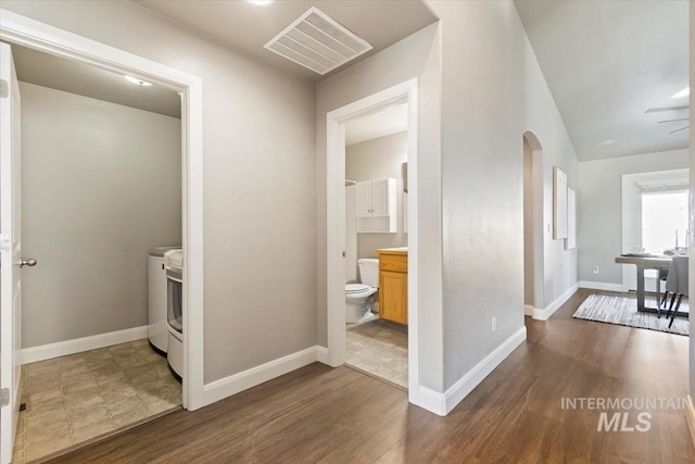 hall with dark hardwood / wood-style flooring and washing machine and dryer