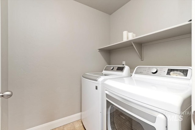 laundry room with light tile patterned flooring and independent washer and dryer