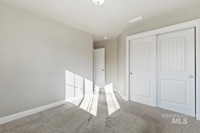 unfurnished bedroom with a closet and carpet flooring