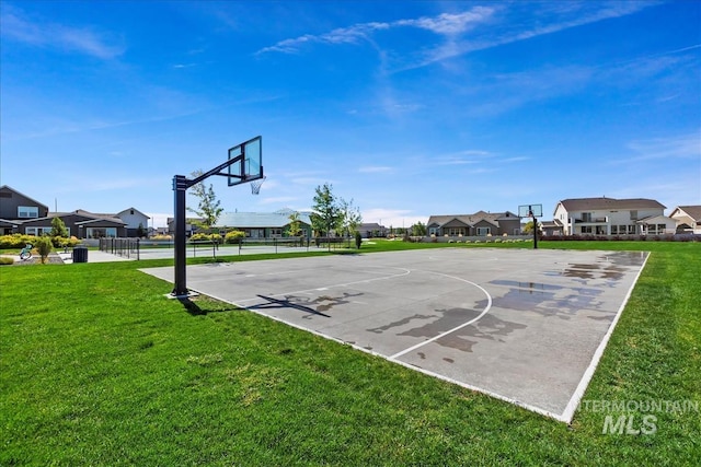 view of basketball court featuring a lawn