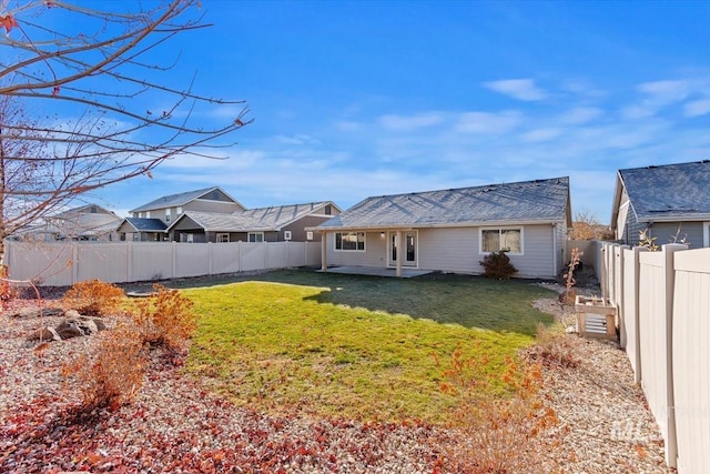 rear view of property with a lawn