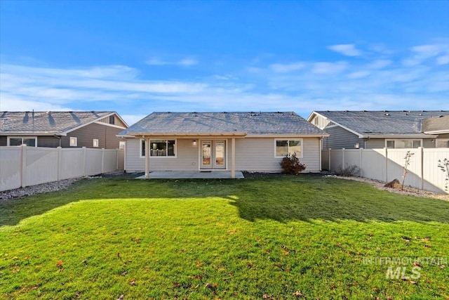 back of property featuring a patio and a yard