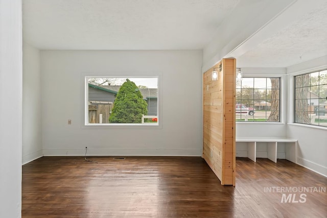 interior space featuring wood finished floors and baseboards