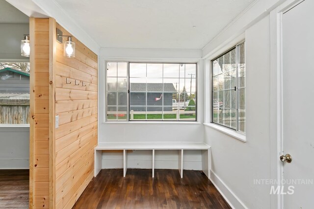 mudroom with baseboards, crown molding, and wood-type flooring