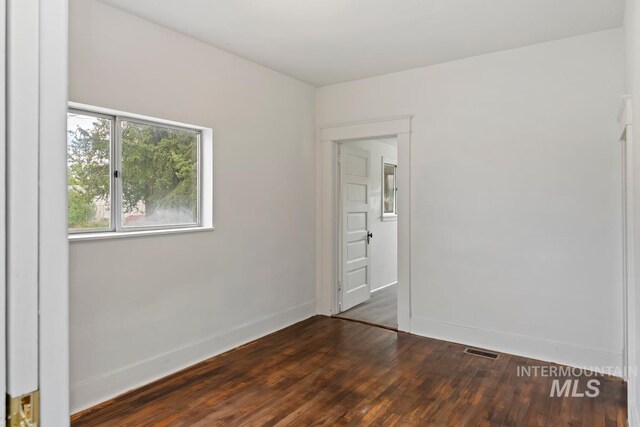 interior space featuring baseboards, visible vents, and wood finished floors