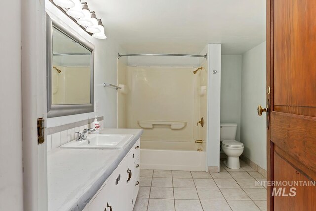 full bath with toilet, vanity, tub / shower combination, and tile patterned floors