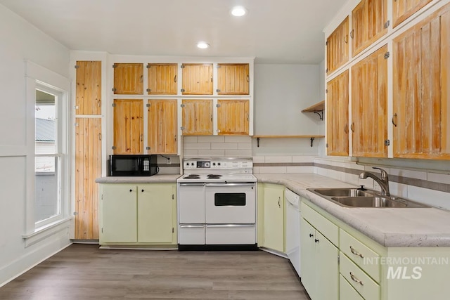 kitchen with recessed lighting, a sink, white appliances, open shelves, and light countertops
