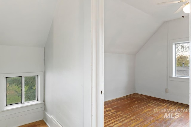 additional living space featuring hardwood / wood-style floors, a ceiling fan, and lofted ceiling