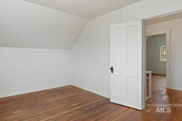 bonus room featuring hardwood / wood-style floors, lofted ceiling, and baseboards