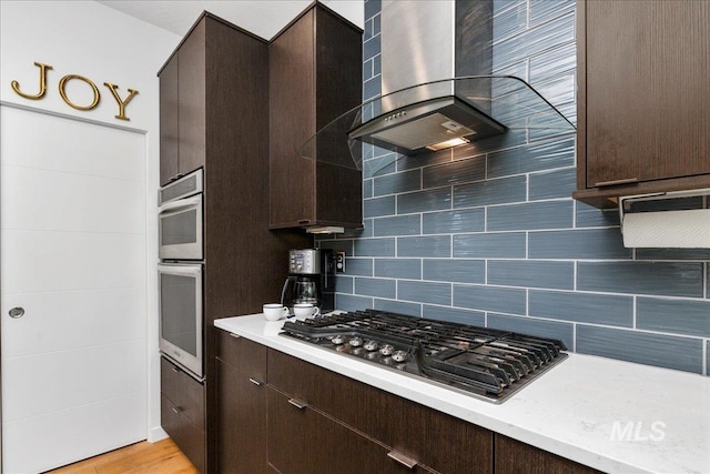 3602 N Prospect Way, Garden City, ID 83714 - kitchen featuring wall chimney exhaust hood, stainless steel gas stovetop, dark brown cabinetry, and light countertops