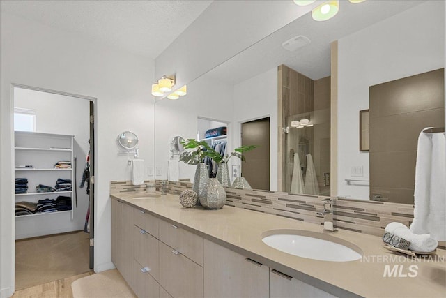 3602 N Prospect Way, Garden City, ID 83714 - bathroom featuring a walk in shower, backsplash, double vanity, and a walk in closet
