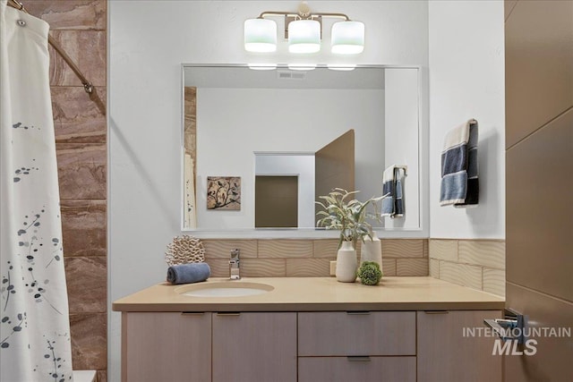 3602 N Prospect Way, Garden City, ID 83714 - full bathroom featuring decorative backsplash, vanity, and a tile shower