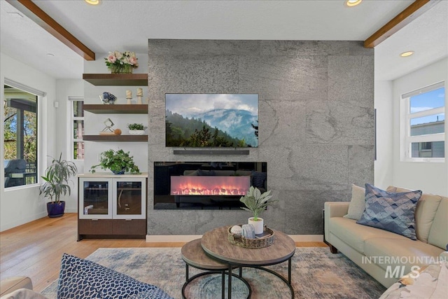 3602 N Prospect Way, Garden City, ID 83714 - living room featuring wood finished floors, a large fireplace, baseboards, recessed lighting, and beam ceiling